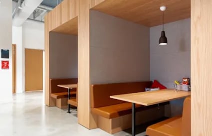 Cozy booth seating in a modern coworking space on Ambli-Bopal Road. Ideal for meetings or solo work.