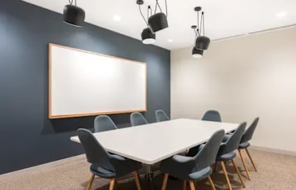 Modern conference room with sleek seating and contemporary lighting, ideal for collaborative work.