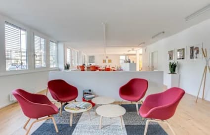 Bright coworking area with modern seating, natural light, and stylish decor. Perfect for collaboration.