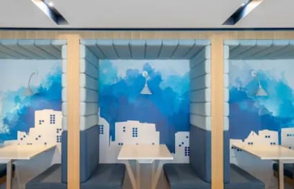 Vibrant, private work pods with artistic wall design in a flexible coworking space on Lazer Street.