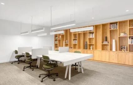 Modern coworking space with sleek desks, ergonomic chairs, and ample lighting on Narmada Road.