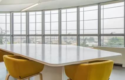 Bright, spacious coworking area with large windows and stylish seating in Kolkata.