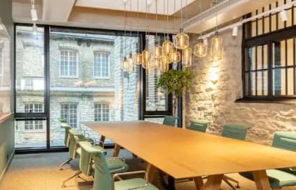 Modern coworking space on Mahatma Gandhi Road, featuring a spacious meeting room with stylish lighting and natural light.