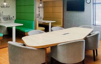 Modern coworking space with vibrant booths and sleek conference table in Gomti Nagar.