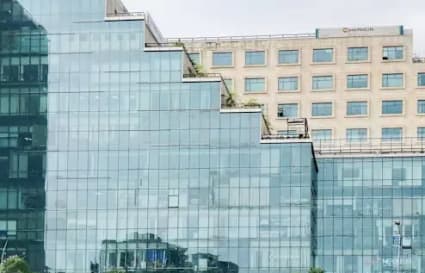 Modern coworking space in Gomti Nagar with sleek glass architecture and lush surroundings.