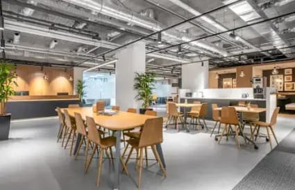 Modern coworking space with open seating, natural light, and contemporary decor in Kozhikode.