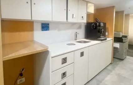 Sleek kitchenette in Nehru Place coworking space, featuring modern appliances and ample storage.