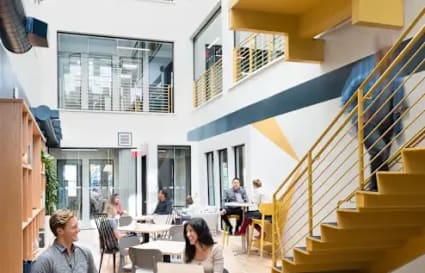 Bright, open coworking space with modern design, ample seating, and natural light. Perfect for collaboration.