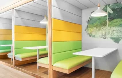 Vibrant, cushioned booths perfect for collaborative work at Cecil Street coworking space.