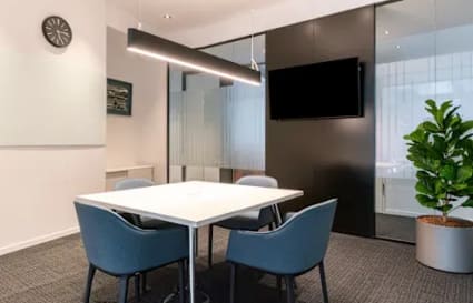 Stylish meeting room with modern furniture, sleek lighting, and a vibrant plant for inspiration.