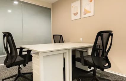 Modern coworking space with ergonomic chairs and a collaborative desk setup. Ideal for productivity.
