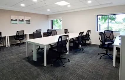 Flexible workspace with modern desks, ergonomic chairs, and natural light in Thudiyalur.