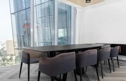 Contemporary meeting room with sleek furnishings and expansive city views. Ideal for collaboration.