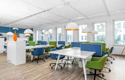 Bright, modern coworking space with vibrant seating and ample natural light.