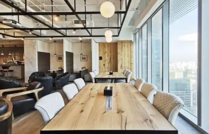 Modern coworking space with natural light, stylish seating, and city views. Perfect for collaboration.