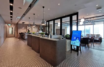 Elegant coworking space with modern design, natural light, and versatile seating in Collyer Quay.