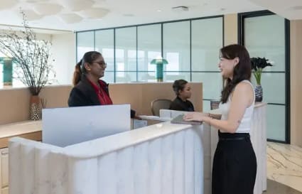 Welcoming reception area in Raffles Place coworking space, featuring modern design and friendly staff.