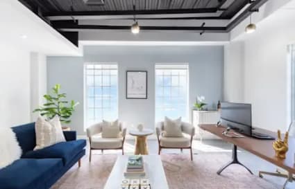 Bright coworking space with modern decor, natural light, and comfortable seating. Perfect for productivity.