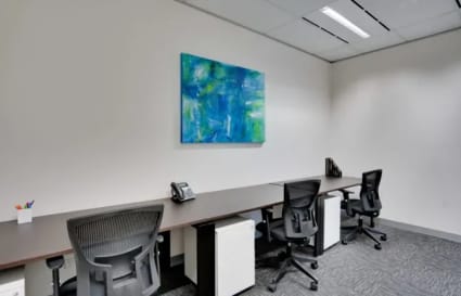 Modern coworking space with executive chairs, ample desk space, and vibrant art in Gangnam.