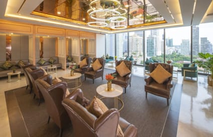 Elegant coworking lounge with plush seating, city views, and modern lighting. Ideal for networking.