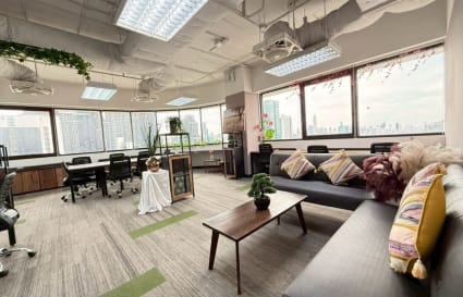 Bright, flexible coworking space with city views, modern decor, and cozy seating in Din Daeng.