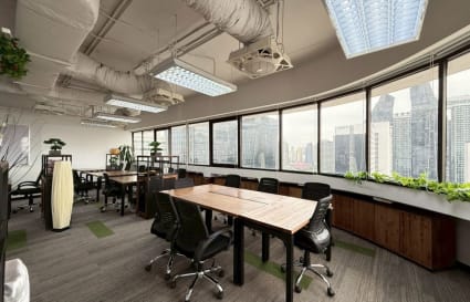 Bright coworking space with city views, modern furnishings, and abundant natural light.
