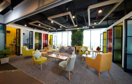 Vibrant coworking space with cozy seating and abundant natural light. Ideal for creative collaboration.