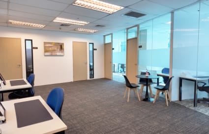 Modern coworking space with private offices, bright lighting, and sleek furnishings on Meralco Ave.