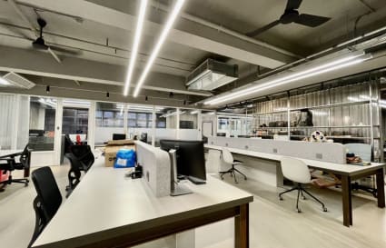 Modern coworking space with open layout, sleek workstations, and ample lighting in New Territories.
