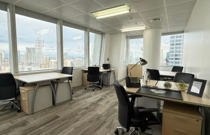 Bright, open coworking space with city views and modern furnishings on Ayala Avenue.