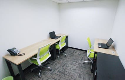 Cozy coworking space with sleek desks and vibrant chairs in Tsim Sha Tsui. Ideal for focused work.