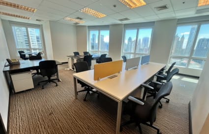 Bright coworking space with city views, ergonomic chairs, and modern desks. Ideal for productivity.