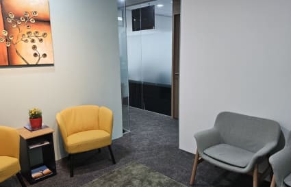 Inviting lounge area with vibrant seating and art, perfect for networking.