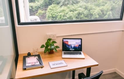 Bright workspace with a scenic view, ideal for focused work. Perfect for flexibility and productivity.