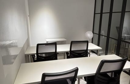 Modern coworking space with ample seating, natural light, and sleek design. Ideal for collaboration.