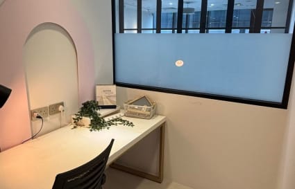 Sleek private workspace with ample natural light and modern furnishings. Ideal for focus and productivity.