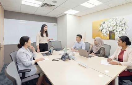Modern coworking space in Raffles Place with a spacious meeting room and collaborative setup.