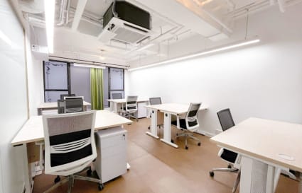 Bright, modern coworking space with flexible seating and abundant natural light.