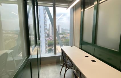 Bright, private workspace with a scenic view, featuring sleek desks and comfortable seating.