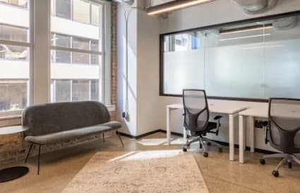Bright coworking space with modern desks, ergonomic chairs, and cozy seating. Ideal for collaboration.