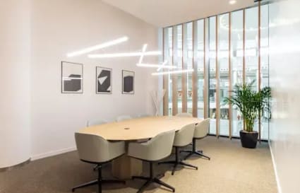 Modern meeting room with sleek lighting and natural light in Downtown Dubai coworking space.