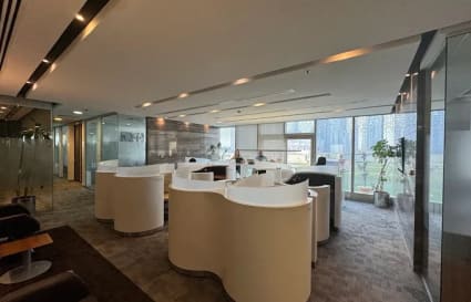 Modern coworking space with sleek workstations, natural light, and city views in Downtown Dubai.