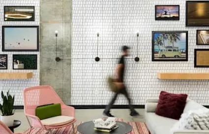 Stylish lounge with modern decor, vibrant seating, and creative artwork in Dubai Media City.