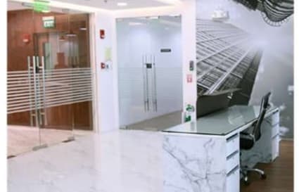 Sleek coworking space with modern décor and glass partitions, ideal for productivity.