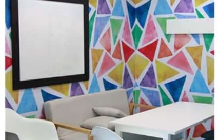 Vibrant coworking space with modern seating and colorful accents. Ideal for creative collaboration.