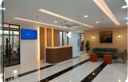 Sleek coworking space with modern reception, cozy seating, and vibrant lighting in Taguig.