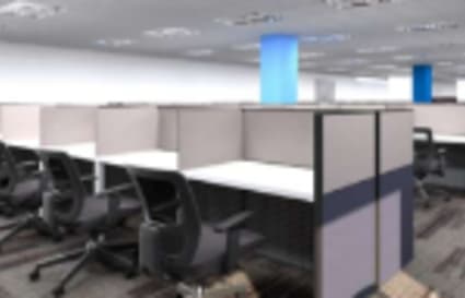 Modern coworking cubicles with ergonomic chairs and ample workspace in a bright, open layout.