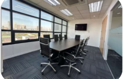 Bright, modern conference room with city views, ideal for meetings and collaborations.