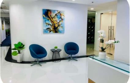 Modern coworking lounge with stylish chairs, vibrant art, and sleek decor on Kalayaan Avenue.