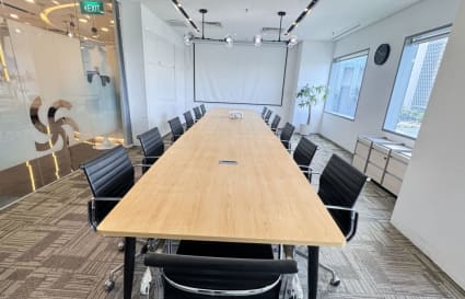 Spacious conference room with modern seating and natural light, perfect for meetings in a prime location.